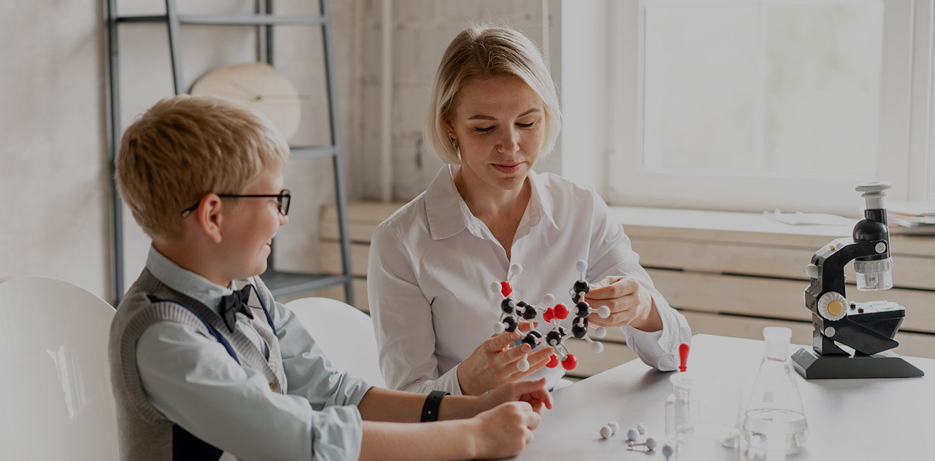 Female science tutor in Minneapolis studying chemistry with student